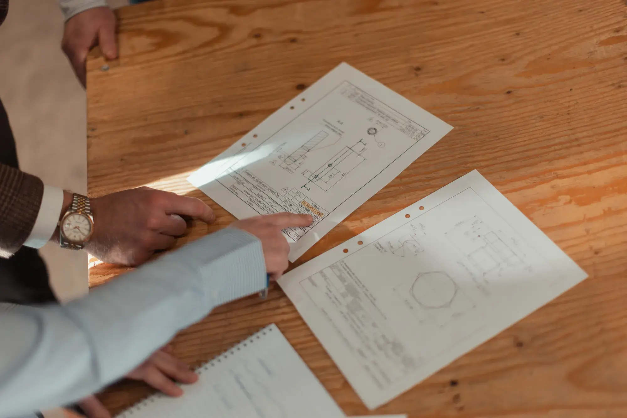 Product drawings on a wooden table